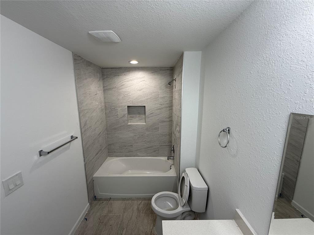 1288 Nackman Road North Port, FL 34288 - Photo 18 of 29 a bathroom with a tub and a shower