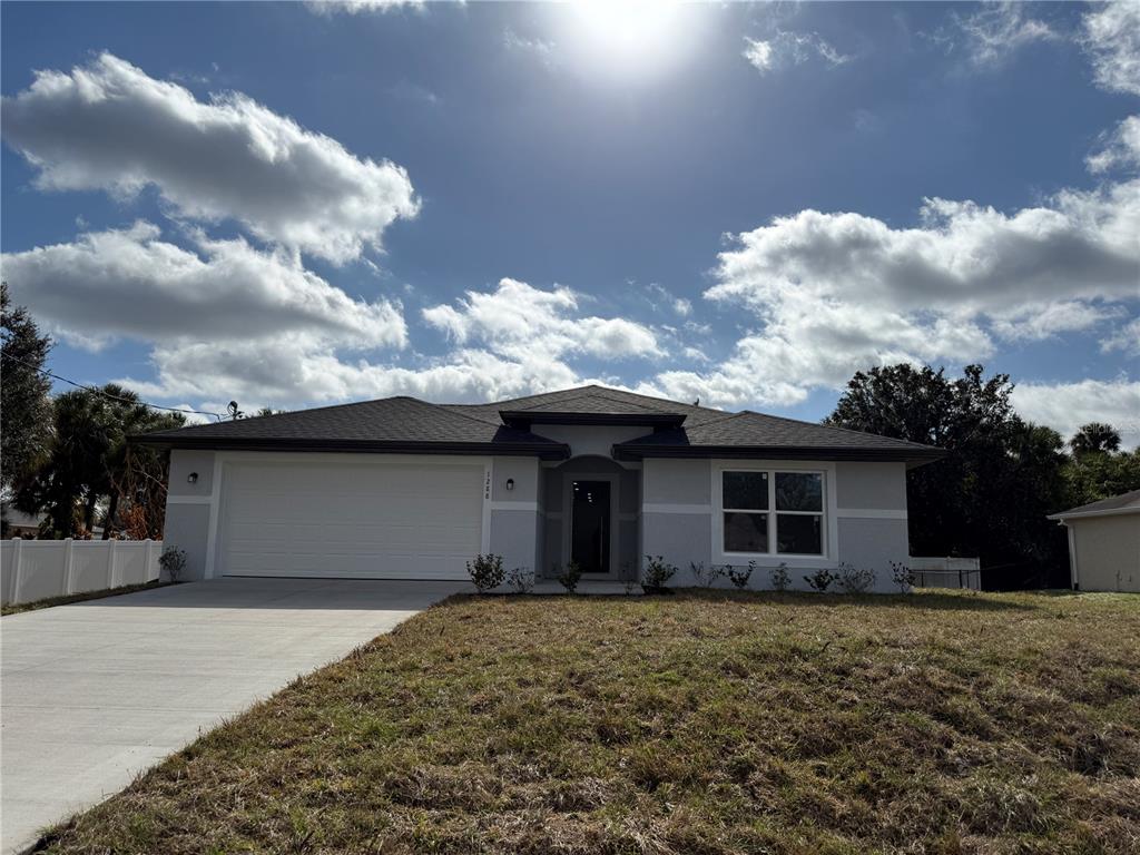 1288 Nackman Road North Port, FL 34288 - Photo 2 of 29 a front view of a house with a garden