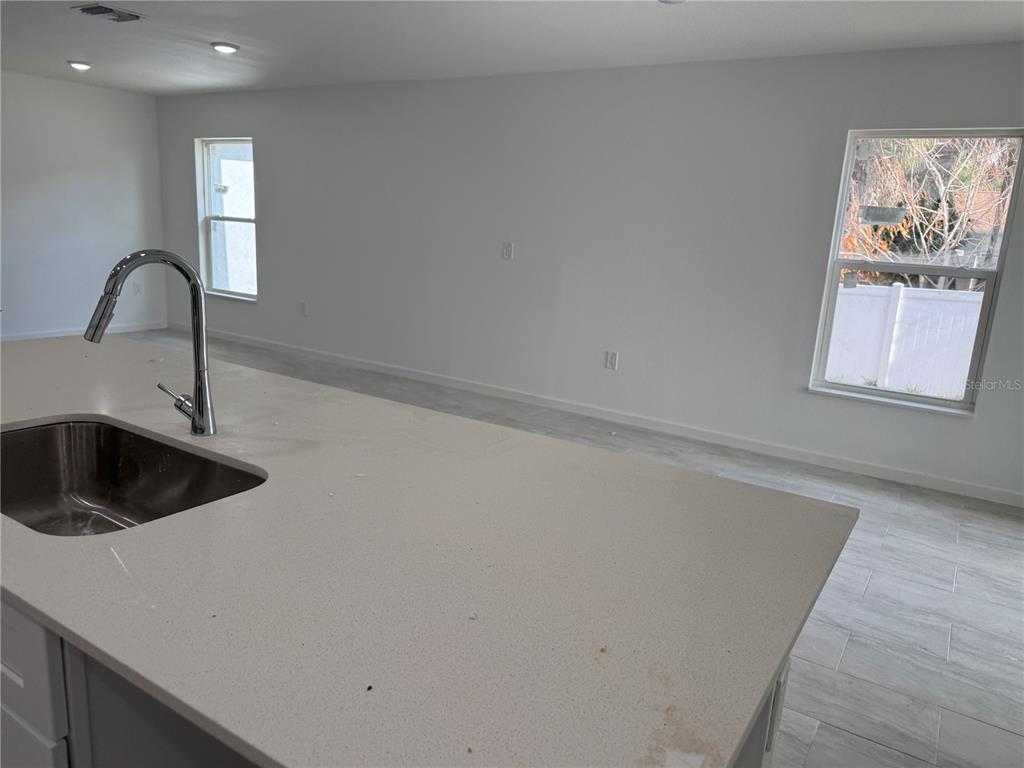 1288 Nackman Road North Port, FL 34288 - Photo 8 of 29 a kitchen with a sink and cabinets