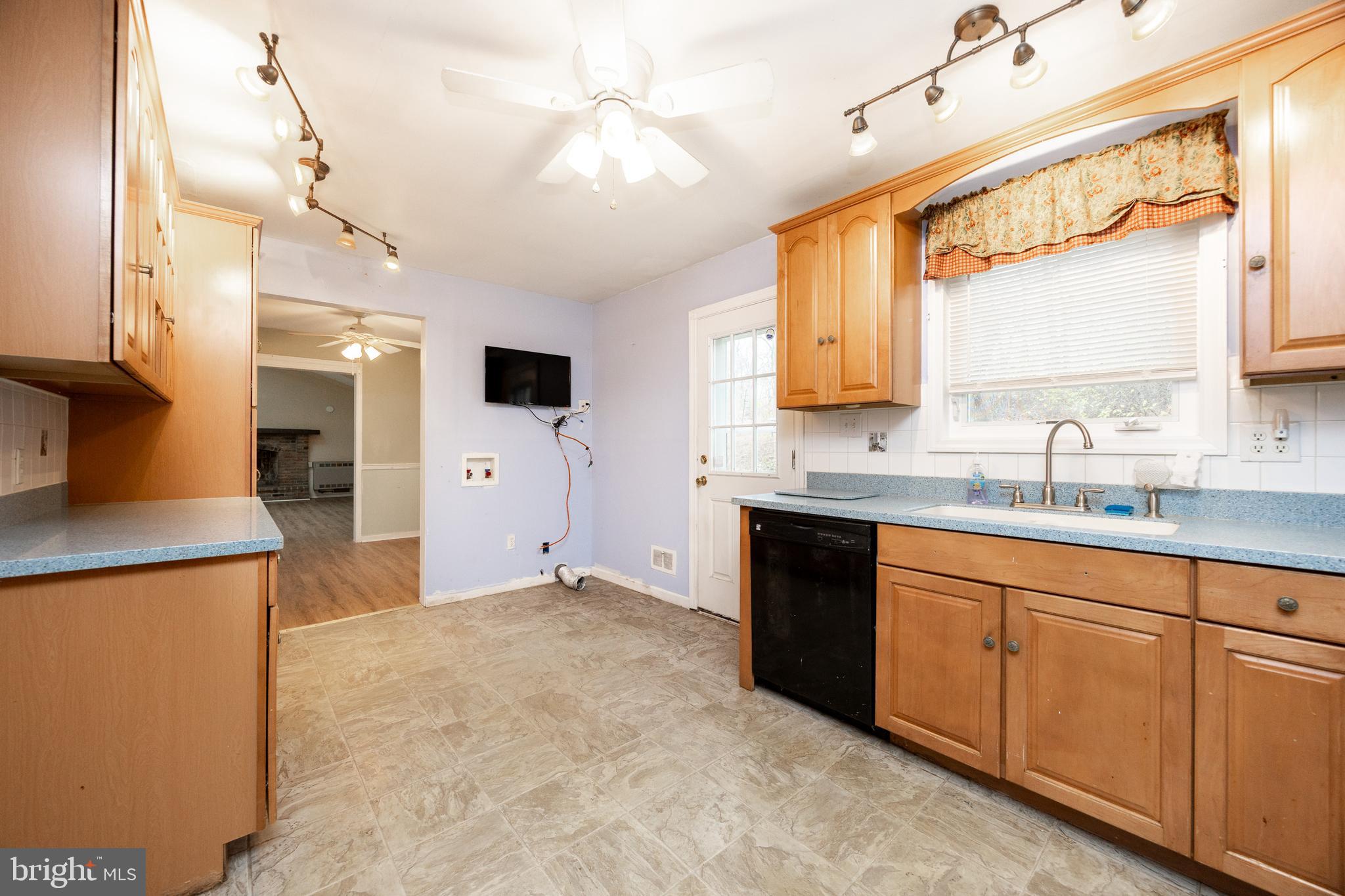 175 Levengood Road Douglassville, PA 19518 - Photo 12 of 33 a large kitchen with a sink and dishwasher a stove top oven with a large window