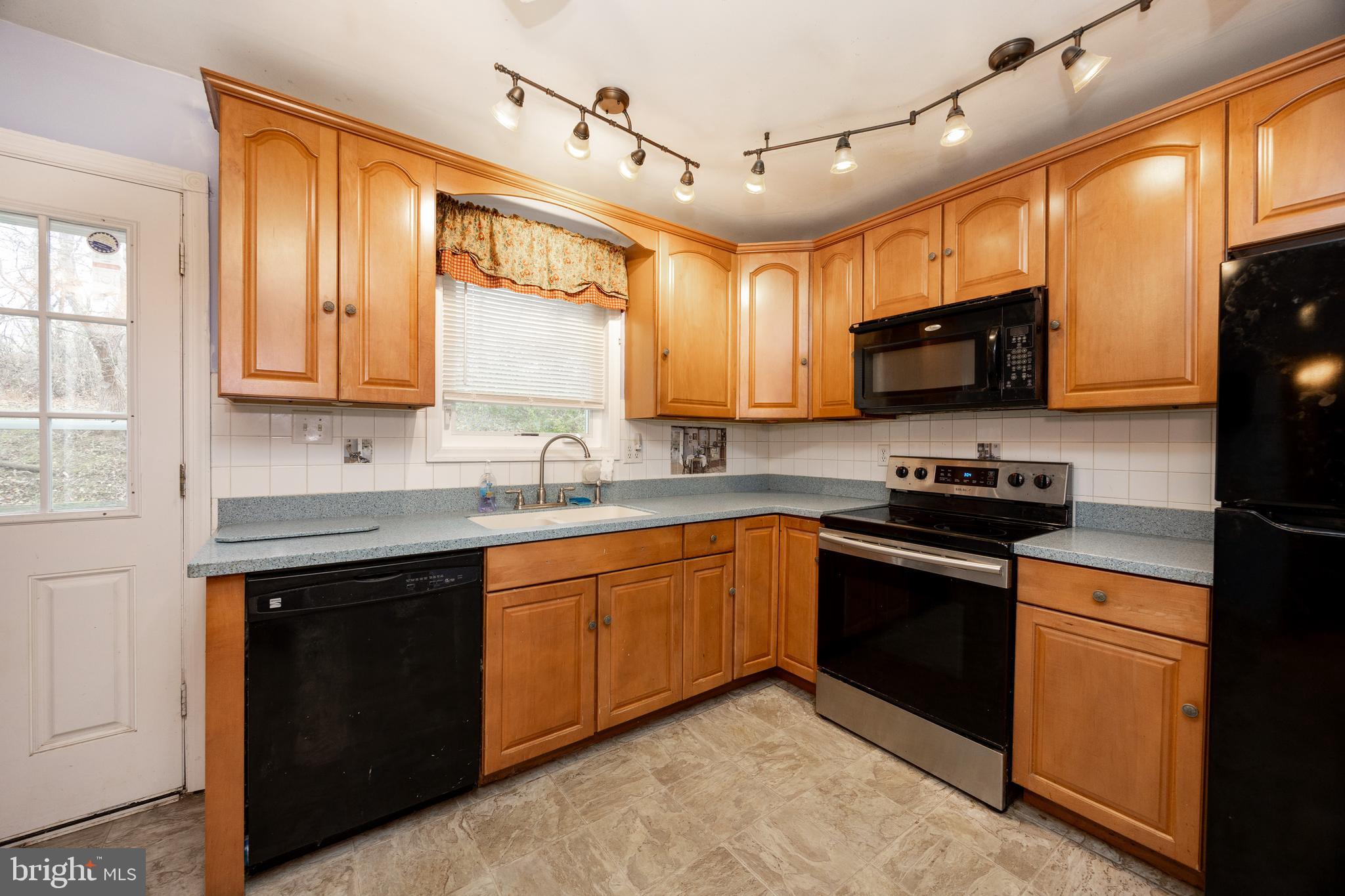 175 Levengood Road Douglassville, PA 19518 - Photo 13 of 33 a kitchen with stainless steel appliances granite countertop a stove sink microwave and window
