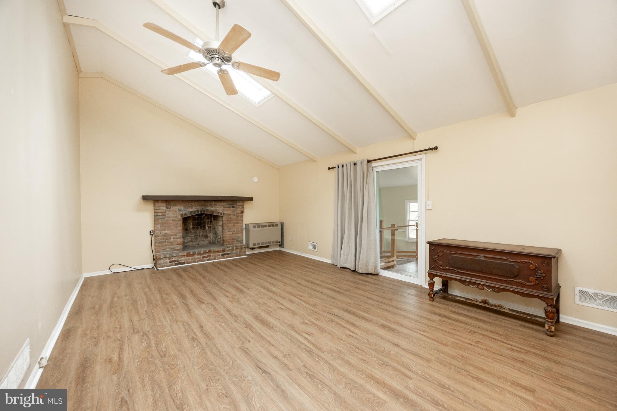 175 Levengood Road Douglassville, PA 19518 - Photo 3 of 33 a view of empty room with wooden floor and fireplace