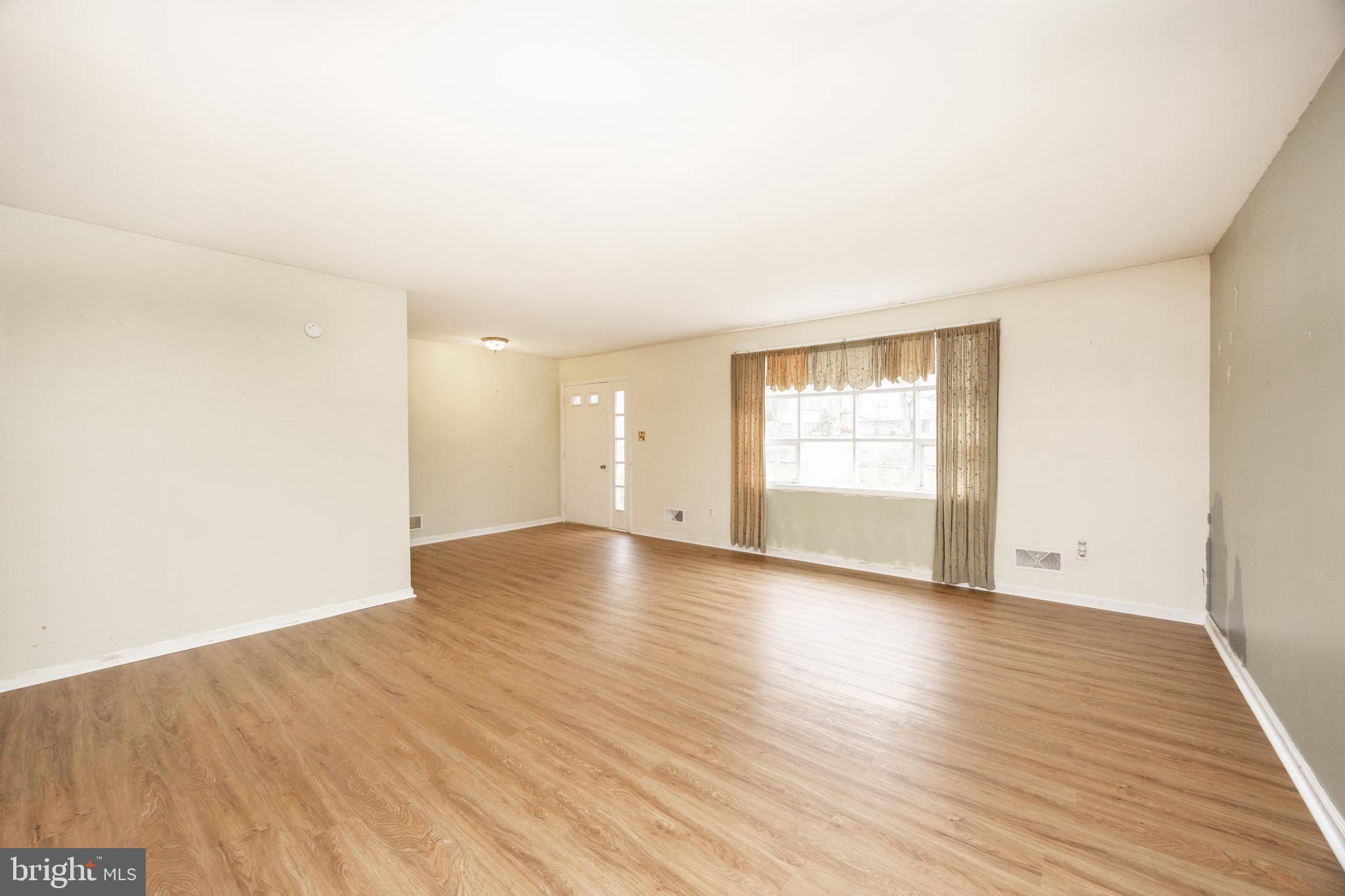 175 Levengood Road Douglassville, PA 19518 - Photo 5 of 33 a view of an empty room with wooden floor and a window