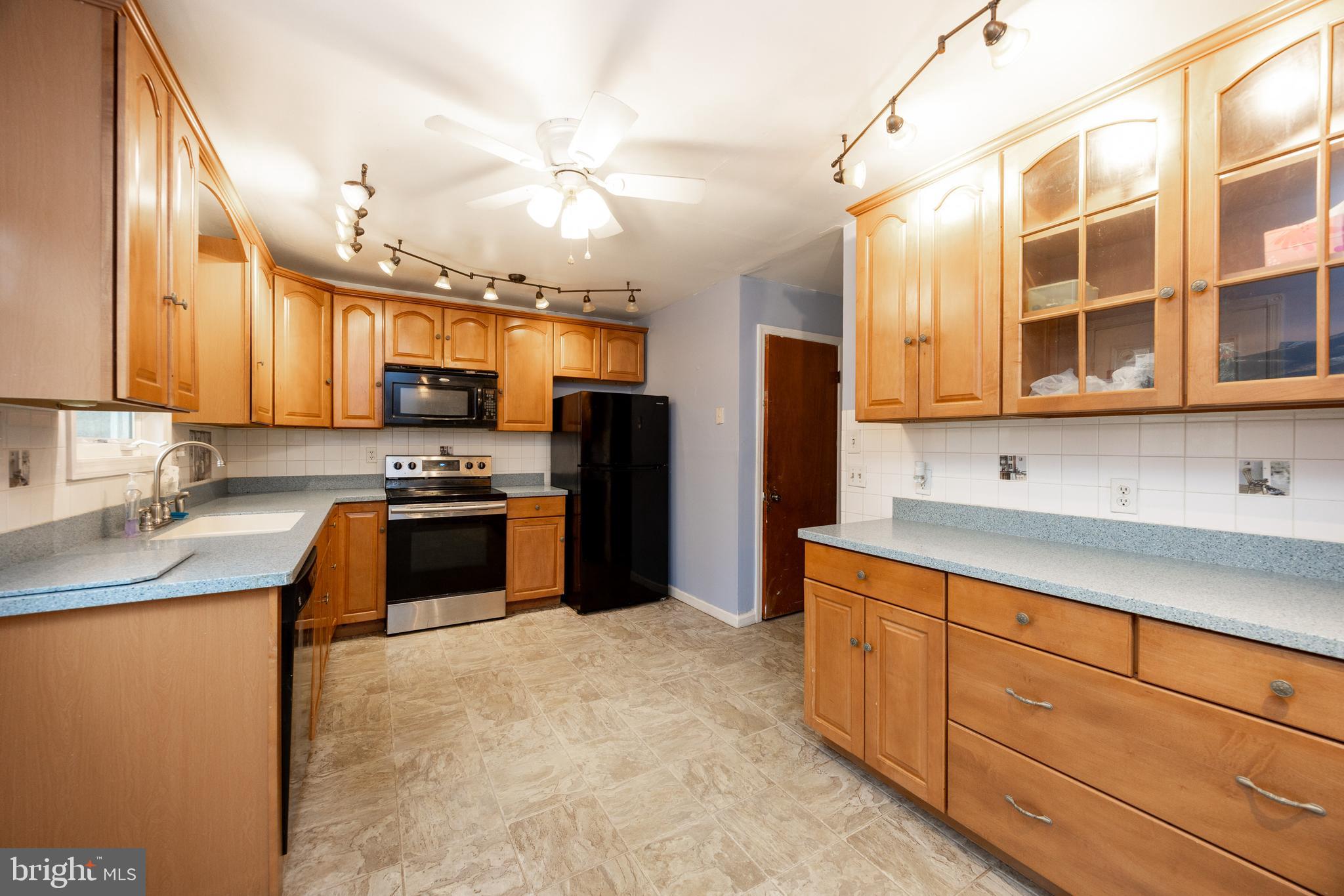175 Levengood Road Douglassville, PA 19518 - Photo 10 of 33 a kitchen with stainless steel appliances granite countertop a stove a sink dishwasher a refrigerator and cabinets with wooden floor