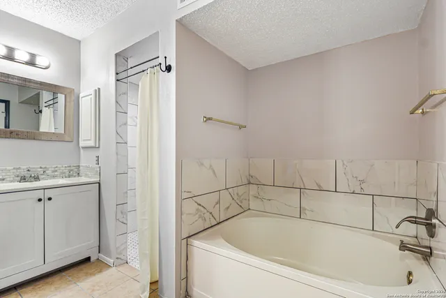 a bathroom with a tub and shower