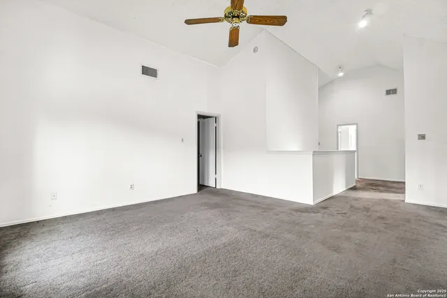 a view of empty room with ceiling fan
