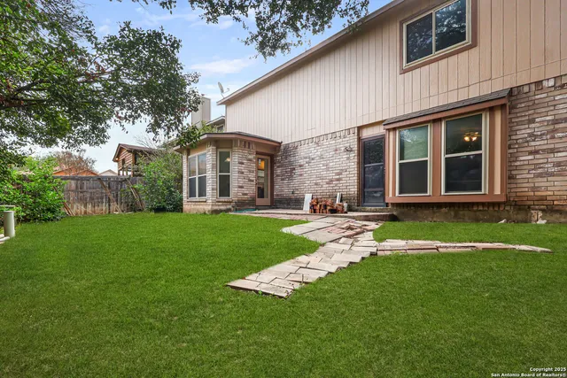 a view of a house with a yard and sitting area
