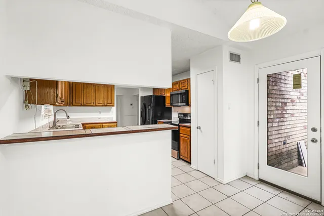 a kitchen with stainless steel appliances a sink and a stove