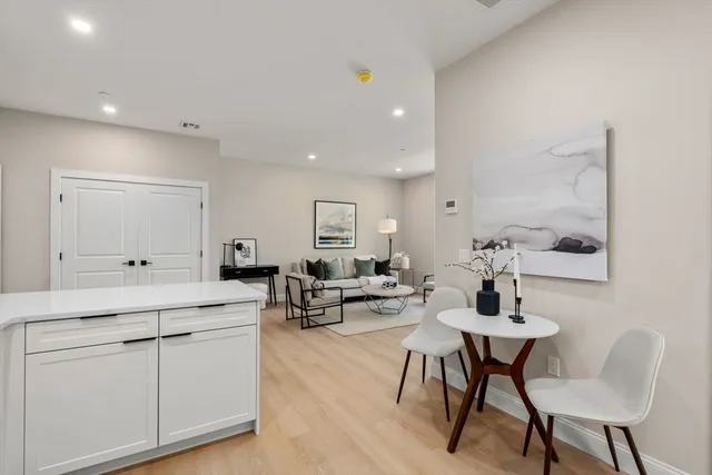 a living room with furniture a rug and white walls
