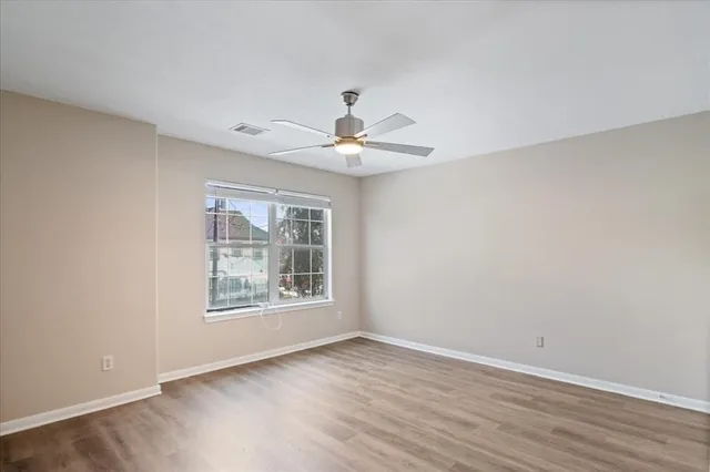 wooden floor in an empty room with a window