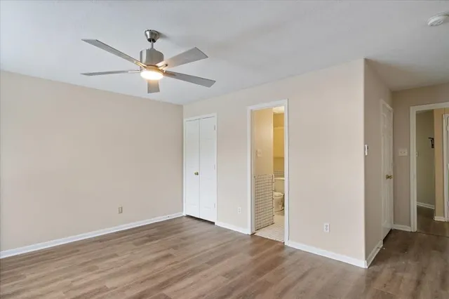 a view of an empty room with wooden floor