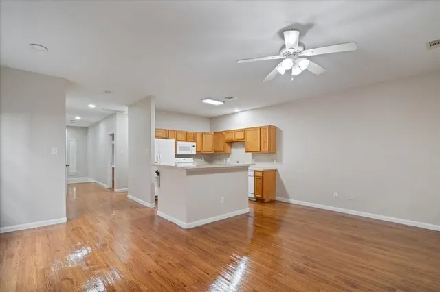a view of a kitchen with wooden floor and a sink