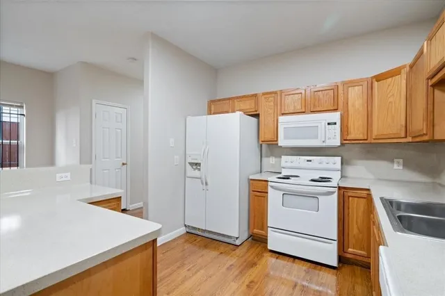 a kitchen with stainless steel appliances a stove a refrigerator and cabinets