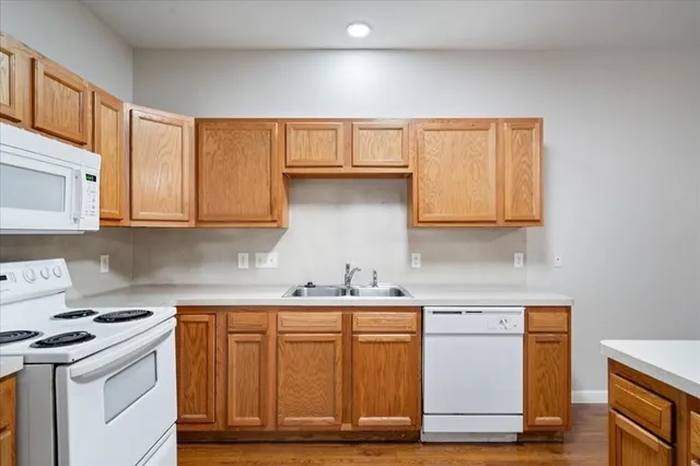 a kitchen with stainless steel appliances granite countertop a sink stove and cabinets