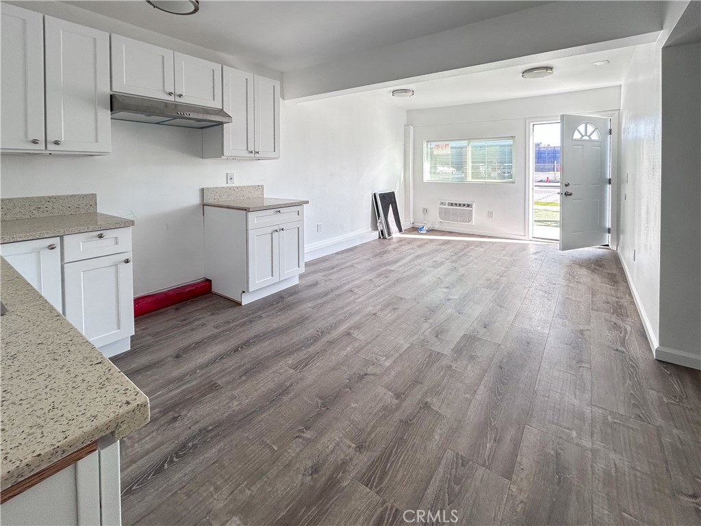 4215 Santa Ana Street, Unit O Huntington Park, CA 90255 - Photo 4 of 10 a kitchen with wooden floors and cabinets