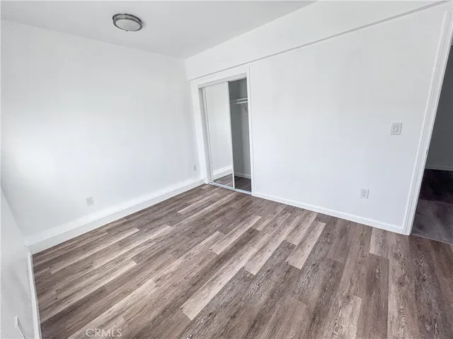 a view of a room with wooden floor and bench