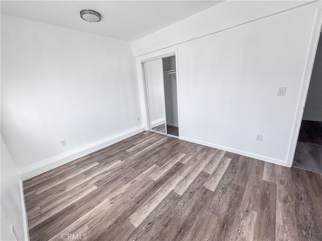 4215 Santa Ana Street, Unit O Huntington Park, CA 90255 - Photo 9 of 10 a view of a room with wooden floor and bench