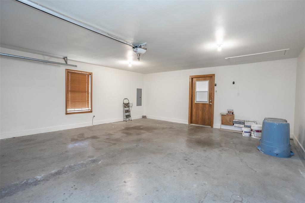 292 Old Spanish Trail Valley View, TX 76272 - Photo 16 of 40 Garage with electric panel and a garage door opener