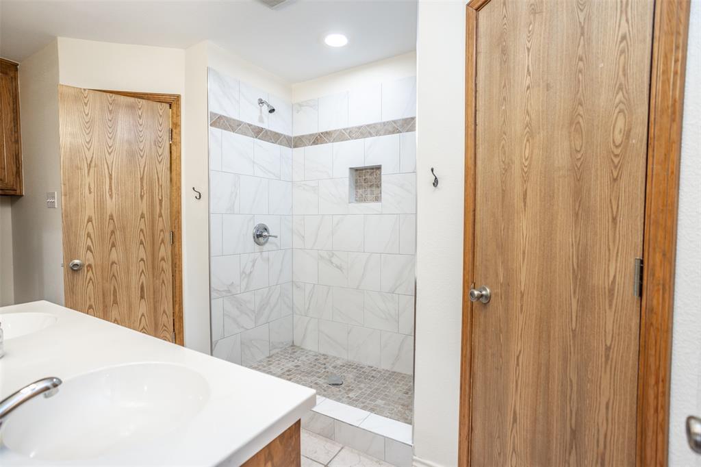 292 Old Spanish Trail Valley View, TX 76272 - Photo 27 of 40 Beautiful Updated MASTER bath with tiled shower, double vanity, and recessed lighting