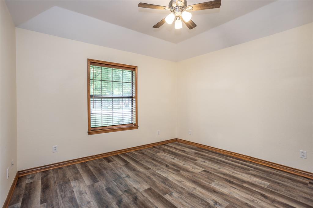 292 Old Spanish Trail Valley View, TX 76272 - Photo 29 of 40 Second bedroom featuring wood finished floors and a ceiling fan