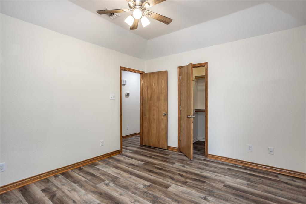 292 Old Spanish Trail Valley View, TX 76272 - Photo 30 of 40 bedroom with dark wood finished floors, a ceiling fan, spacious walk-in closet