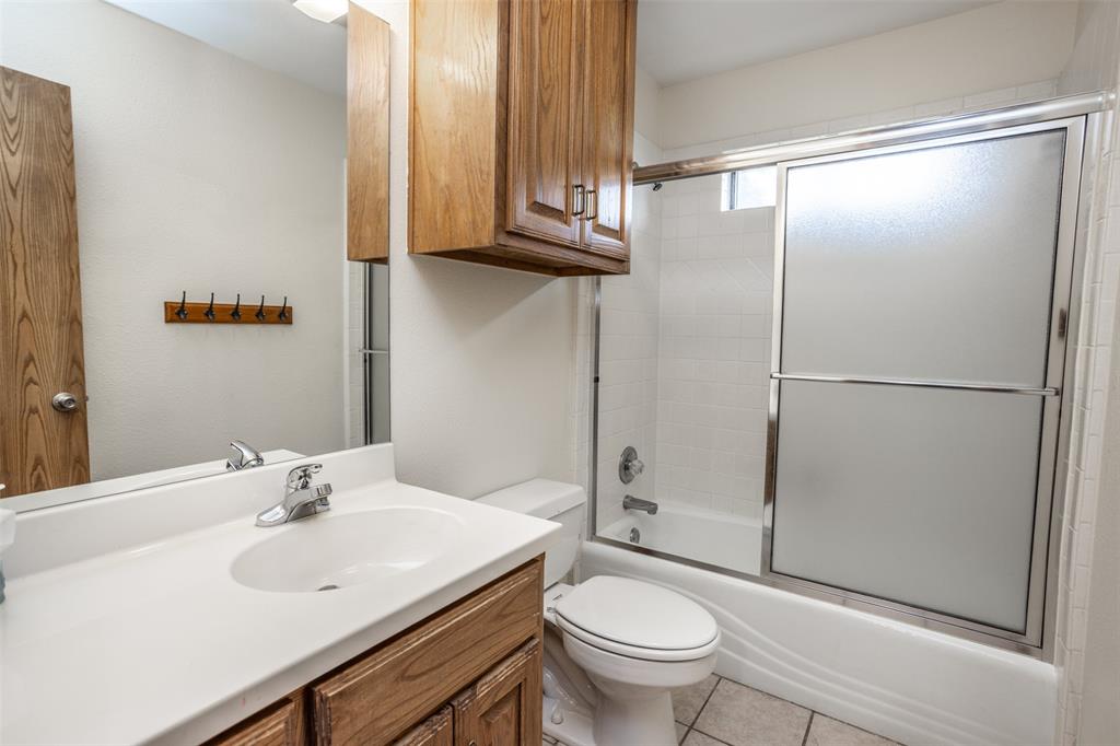292 Old Spanish Trail Valley View, TX 76272 - Photo 32 of 40 Second Full bath featuring vanity, shower / bath combination with glass door, and tile patterned flooring