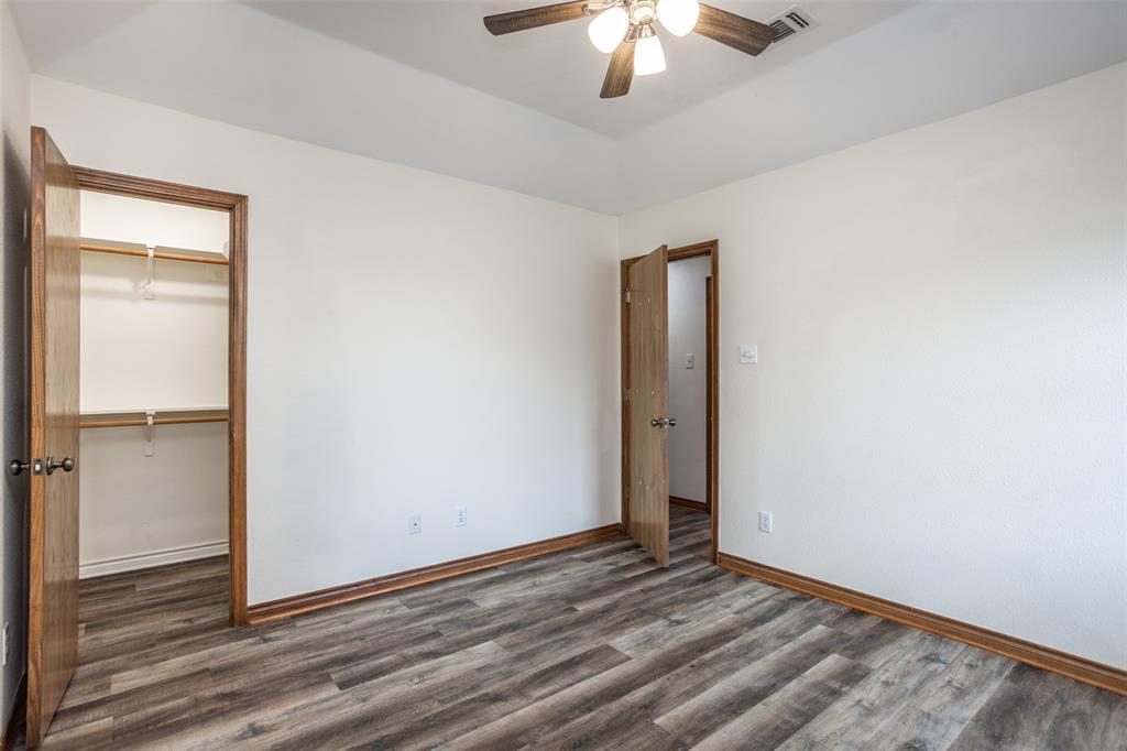 292 Old Spanish Trail Valley View, TX 76272 - Photo 33 of 40 Third bedroom with wood finished floors, a closet, a walk in closet, and ceiling fan