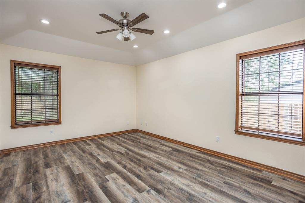 292 Old Spanish Trail Valley View, TX 76272 - Photo 34 of 40 Empty room with wood finished floors, a ceiling fan, recessed lighting, and lofted ceiling