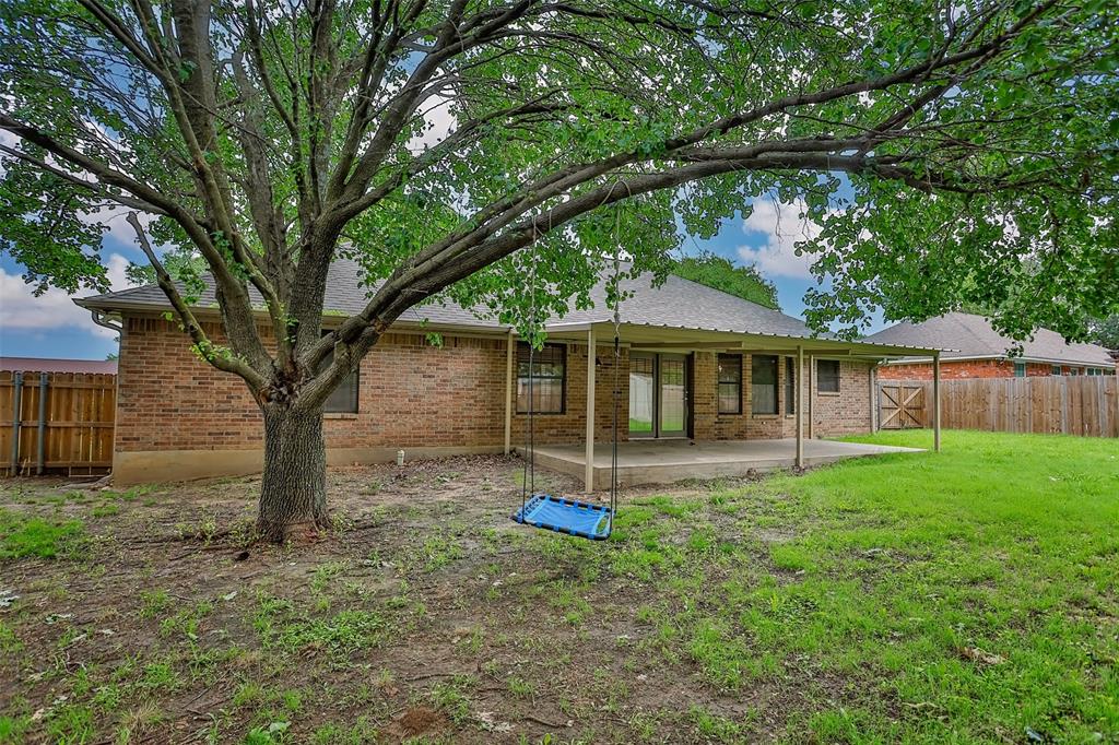 292 Old Spanish Trail Valley View, TX 76272 - Photo 39 of 40 Rear view of property with a patio, a fenced backyard, and brick siding