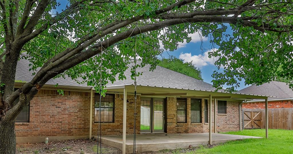 292 Old Spanish Trail Valley View, TX 76272 - Photo 40 of 40 Rear view of house with roof with shingles, brick siding, and a patio area