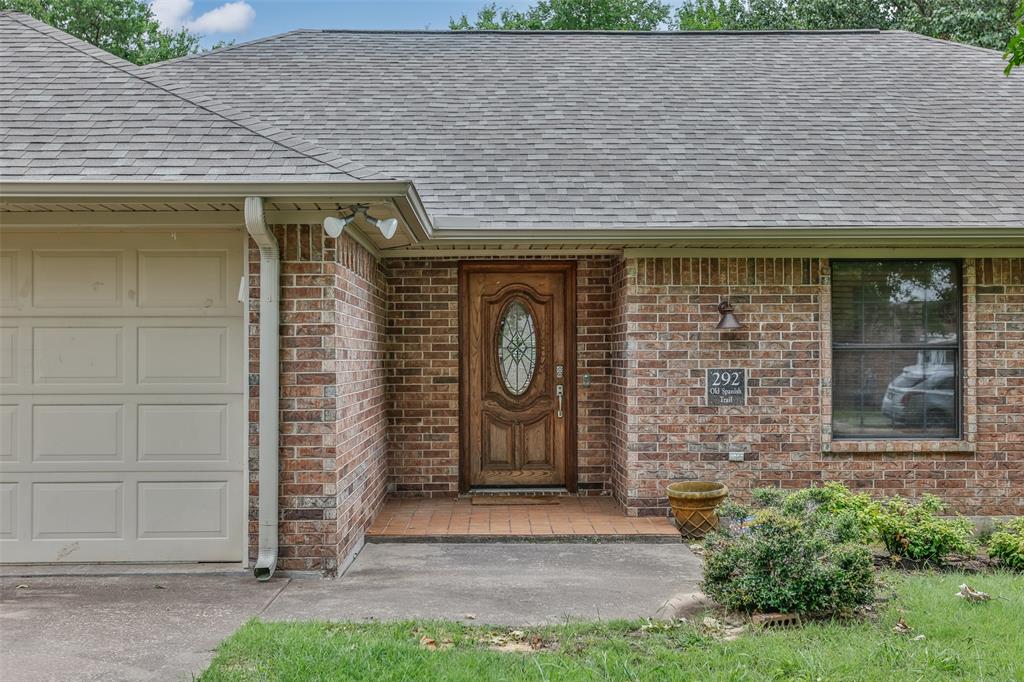 292 Old Spanish Trail Valley View, TX 76272 - Photo 4 of 40 Entrance to property featuring a shingled roof, brick siding, and a garage
