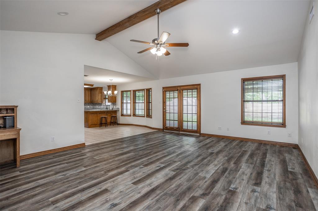 292 Old Spanish Trail Valley View, TX 76272 - Photo 6 of 40 Large Living room featuring beam ceiling, a ceiling fan, a chandelier, wood finished floors, and plenty of natural light
