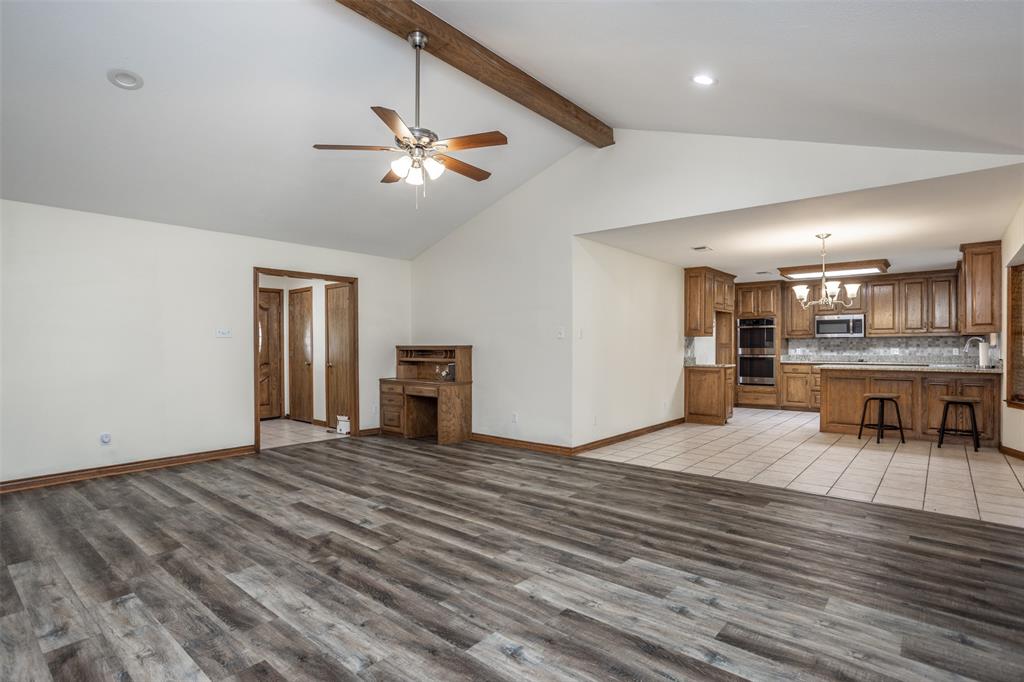 292 Old Spanish Trail Valley View, TX 76272 - Photo 8 of 40 Large living room featuring a chandelier, light wood-style flooring, beam ceiling, ceiling fan, and high vaulted ceiling