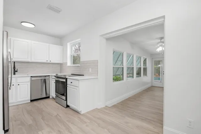 a kitchen with a stove top oven sink and cabinets