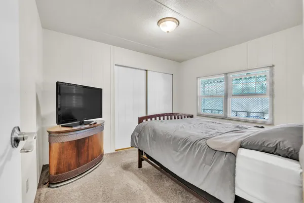 a bedroom with a bed and a window