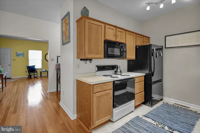 a kitchen with stainless steel appliances a stove microwave and a refrigerator