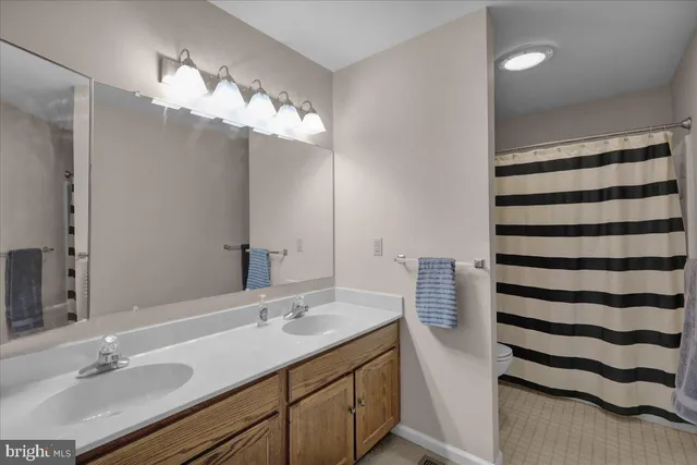 a bathroom with a sink a mirror and a light fixture
