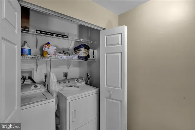 a view of storage and utility room with washer and dryer