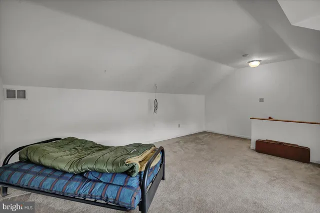 a bedroom with a bed and a desk