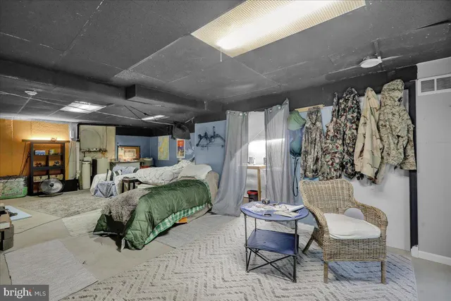 a bed room with a bed and a chair