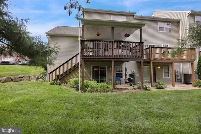 a view of a house with a yard and sitting area