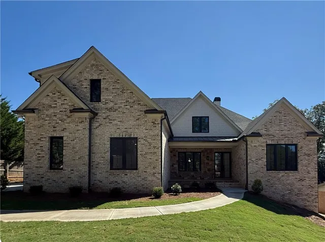 a front view of a house with a yard