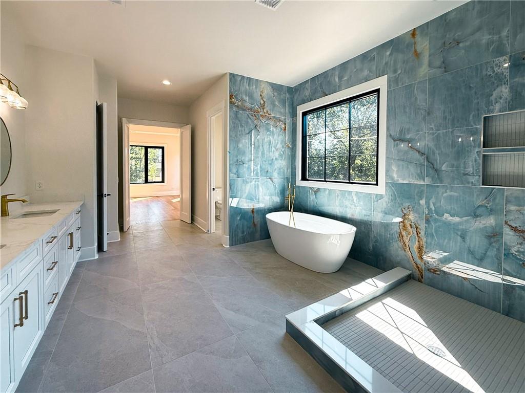 3700 Robinson Road Northeast Marietta, GA 30068 - Photo 18 of 49 a spacious bathroom with a granite countertop sink and a bathtub