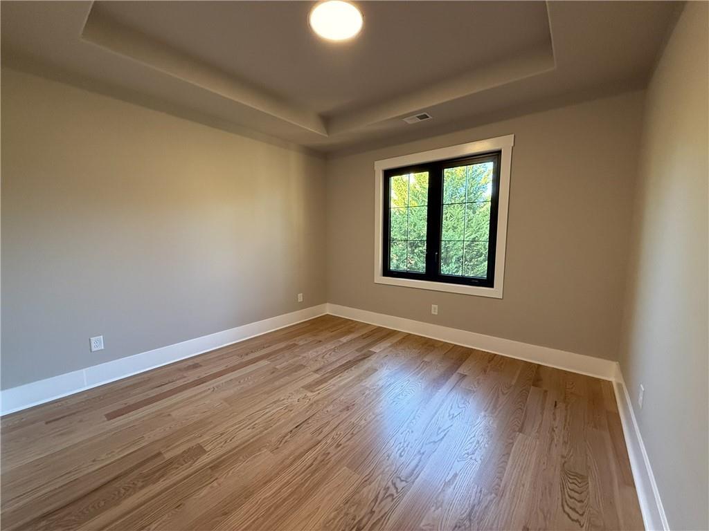 3700 Robinson Road Northeast Marietta, GA 30068 - Photo 20 of 49 a view of an empty room with wooden floor and a window
