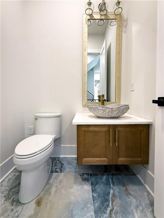 3700 Robinson Road Northeast Marietta, GA 30068 - Photo 22 of 49 a bathroom with a granite countertop toilet and sink