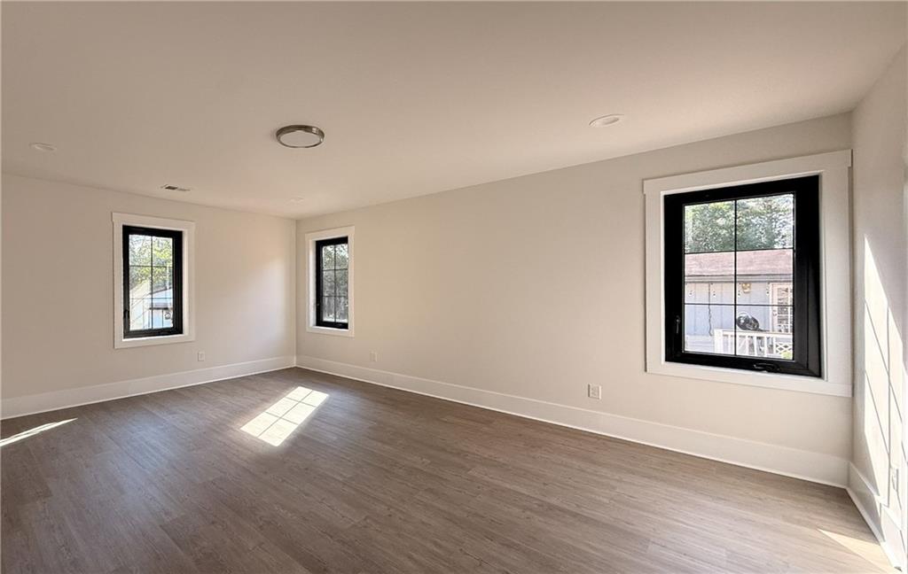 3700 Robinson Road Northeast Marietta, GA 30068 - Photo 41 of 49 an empty room with wooden floor and windows