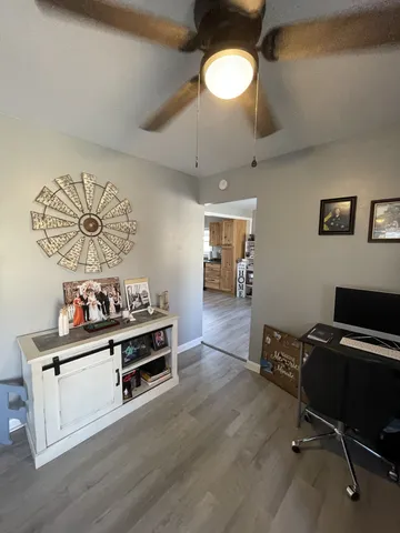 a view of a workspace with furniture and a window