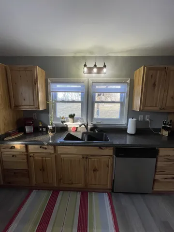 a kitchen with a sink cabinets and window