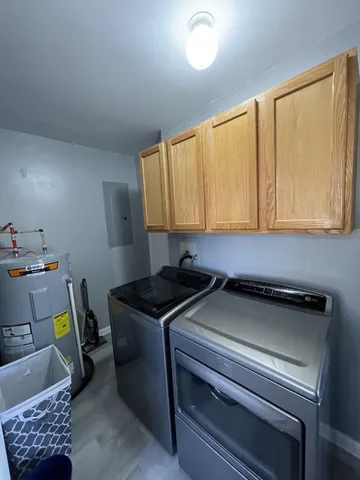 a utility room with sink dryer and washer