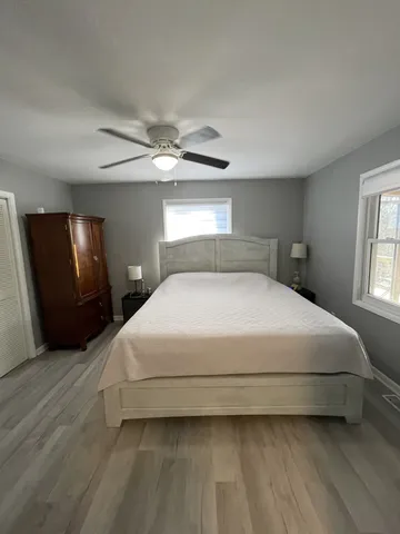a bedroom with a bed lamp and a window